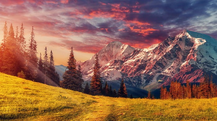 Fototapeta Awesome Alpine Highlands In Sunny Day. Scenic Image Of Fairy-Tale Landscape With Colorful Sky Under Sunlit, Over The Majestic Rock Mountains. Wild Area. Megical Natural Background. Creative Image